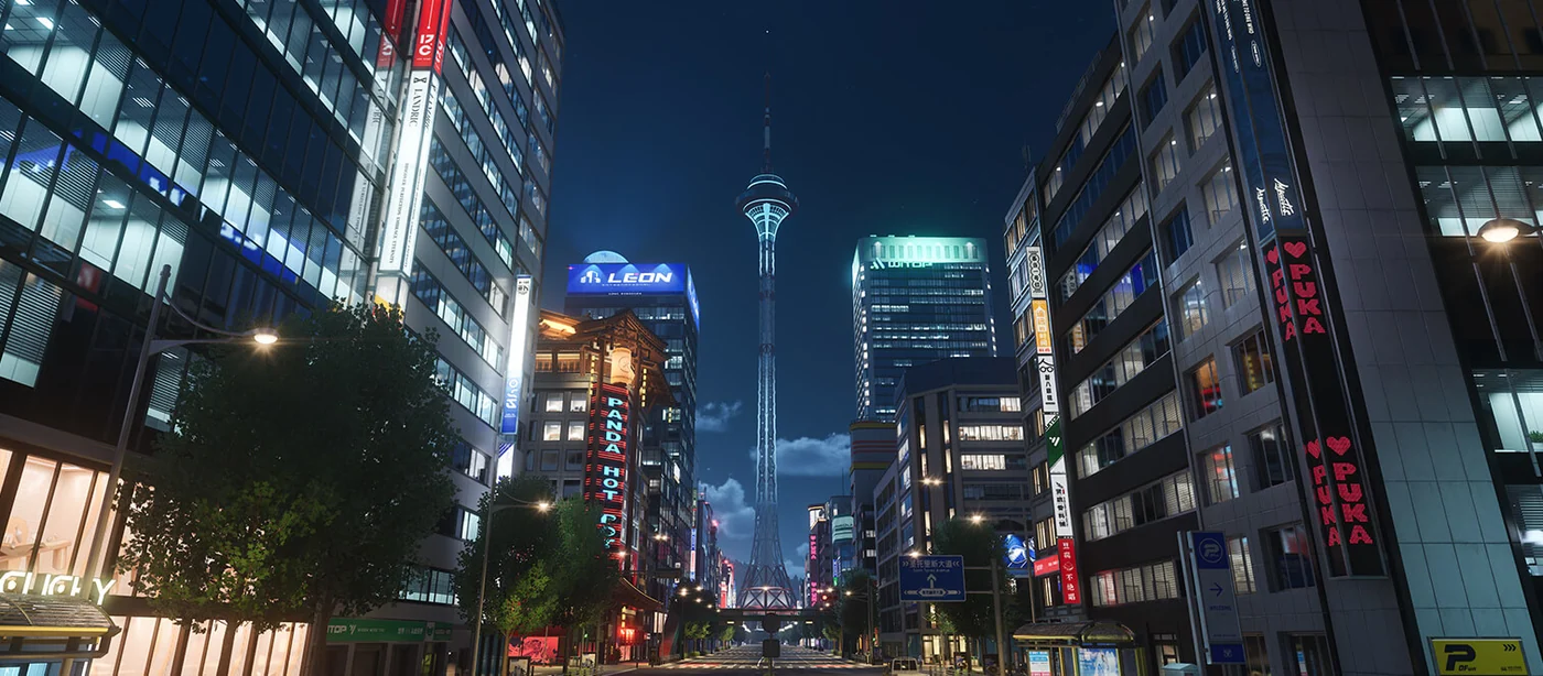 An illuminated city avenue and tall buildings at night